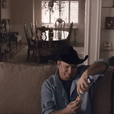 Man In Cowboy Hat Opening Beer GIF