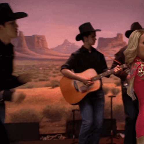 Man in Cowboy Hat Playing Guitar