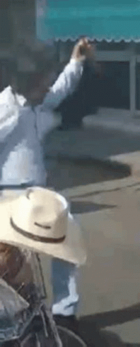Man in Cowboy Hat Riding Bicycle