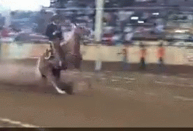 Man in Cowboy Hat Riding Horse on Dirt Track