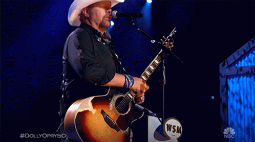Man in Cowboy Hat Singing Into Microphone #Dolly Opry50