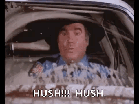 Man in Cowboy Hat Sitting in Car Saying Hush Hush