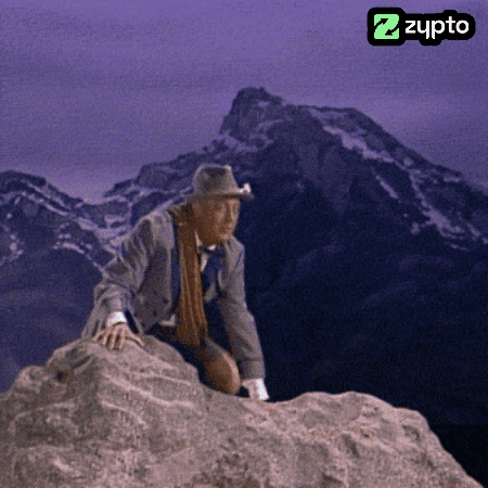 Man in Cowboy Hat Sitting on Rock
