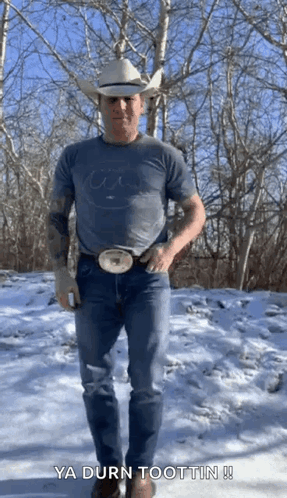 Man in Cowboy Hat Standing in Snow