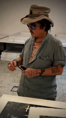 Man in Cowboy Hat Sunglasses With Tattoo Saying N