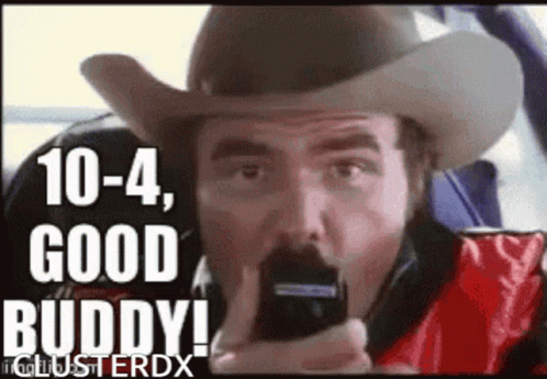 Man in Cowboy Hat Talking on Phone Eating Chips