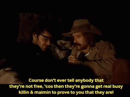 Man in Cowboy Hat Talking to Man in Glasses