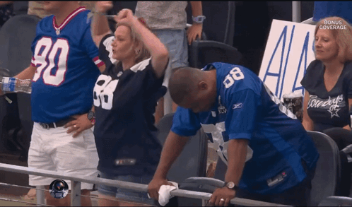 Man In Cowboy Jersey Wipes Face GIF