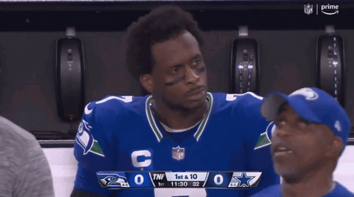 Man in Cowboys Jersey Looking at Scoreboard