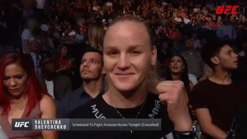 Man in Crowd Holding Valentina Shevchenko Sign