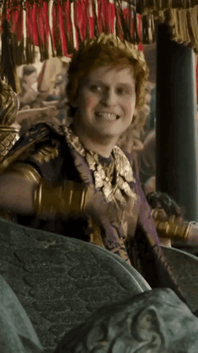 Man In Crown And Purple Robe Smiling GIF