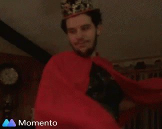 Man in Crown and Red Cape Smiling