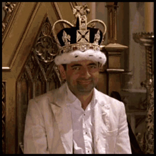 Man In Crown And White Suit On Throne GIF