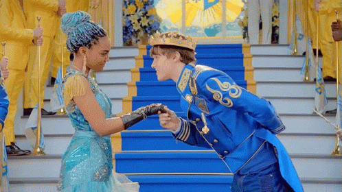 Man in Crown Kissing Woman in Blue Dress