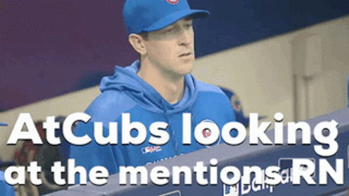 Man in Cubs Hat Standing in Dugout