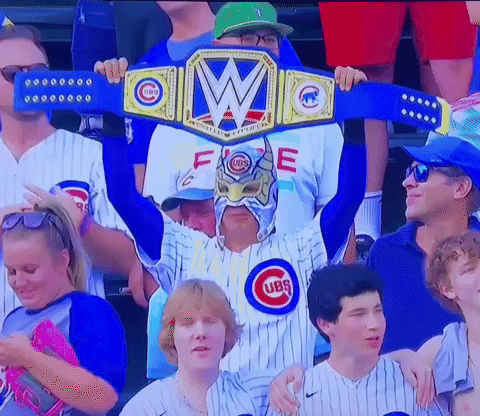 Man in Cubs Jersey Holding Championship Belt