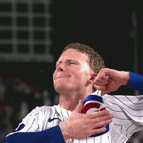 Man In Cubs Jersey Holding Shoulder GIF
