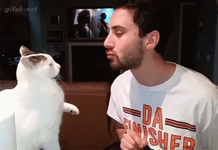 Man in Da Finisher Shirt Kissing Cat