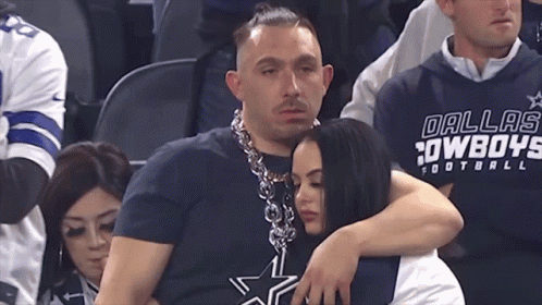 Man in Dallas Cowboys Shirt Hugging Woman