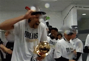 Man in Dallas Shirt Holding Trophy
