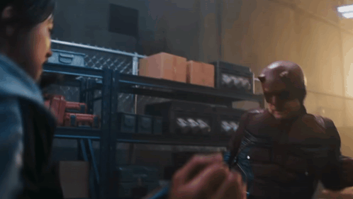 Man in Daredevil Costume Talking to Woman