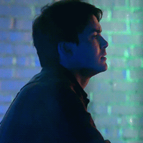 Man in Dark Room With Blue and Green Lights