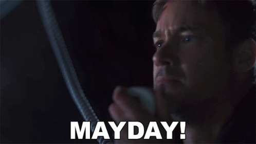 Man In Dark Room With Mayday On Face GIF