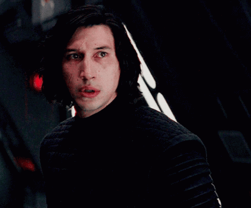 Man In Dark Room With Red Light Behind GIF