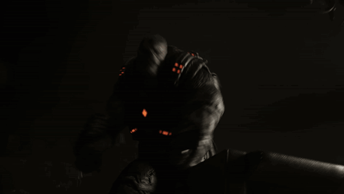 Man In Dark Room With Red Light On Arm GIF