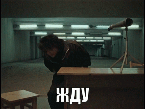 Man in Dark Room with Telescope жду