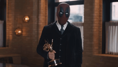 Man In Deadpool Mask Holding Trophy GIF