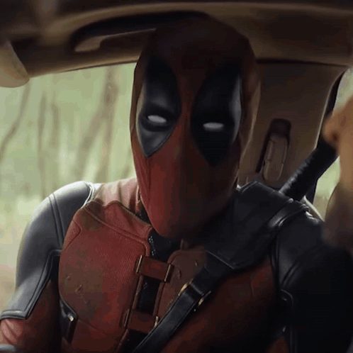 Man in Deadpool Suit Sitting in Car