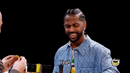 Man in Denim Jacket Saying Yeah Near Bottles