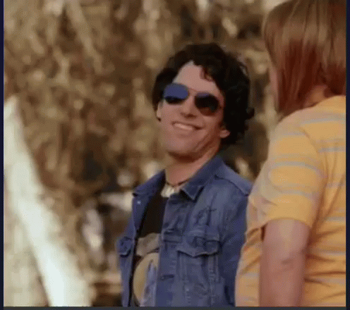 Man in Denim Jacket Smiling and Talking