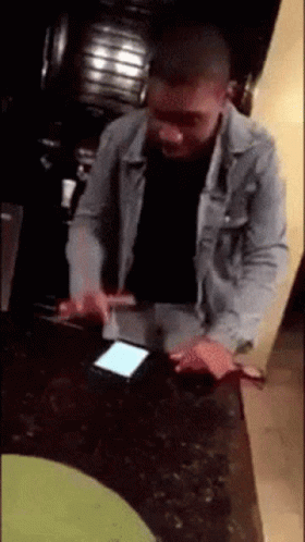 Man in Denim Jacket Using Phone