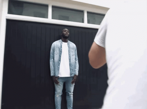 Man in Denim Shirt at Garage Door