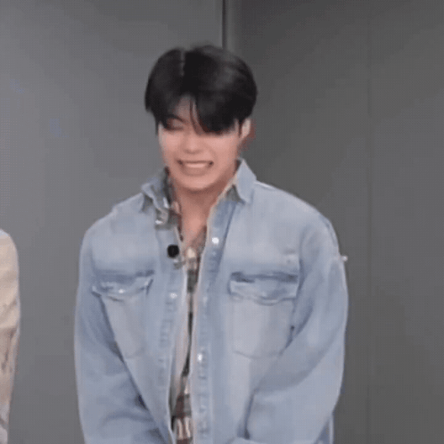 Man in Denim Shirt Laughing Hands Behind Back