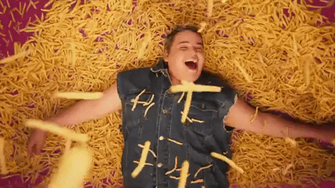 Man in Denim Vest Laying on French Fries