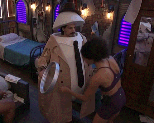 Man in Detective Costume Next to Woman in Purple Underwear