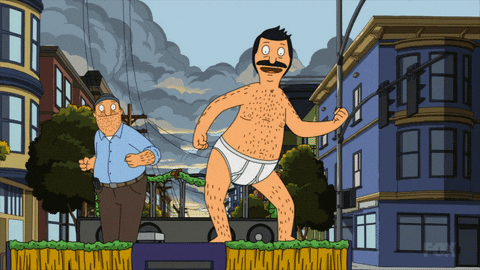 Man in Diaper Standing Before Buildings