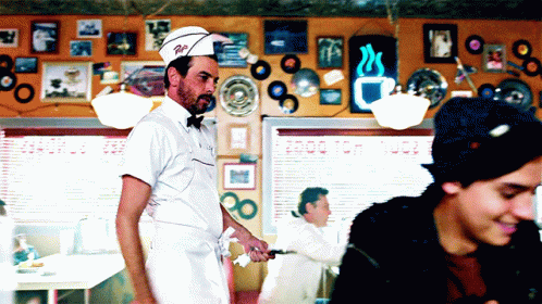Man in Diner Wearing Hat Saying R.I