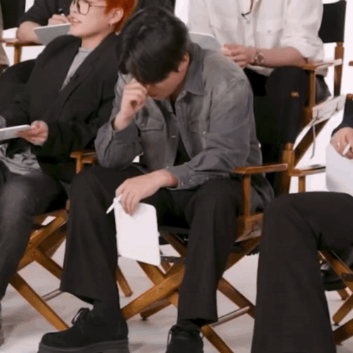 Man in Director's Chair With Paper