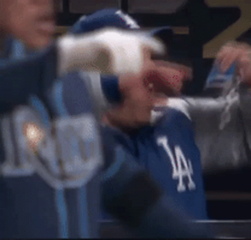 Man in Dodgers Hat Sitting in Dugout