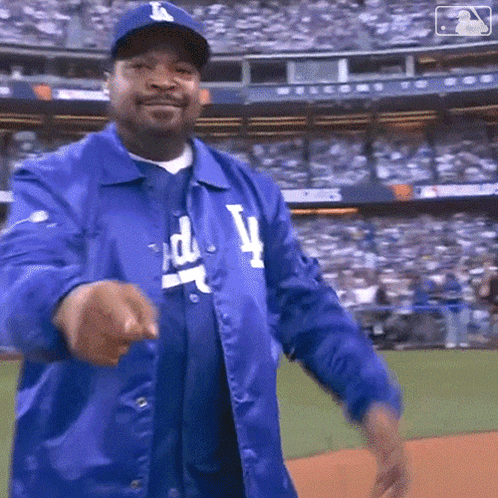 Man in Dodgers Jacket and Hat Pointing