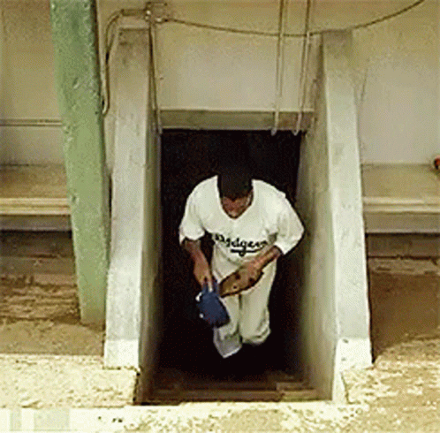 Man in Dodgers Jersey Walking Out Staircase