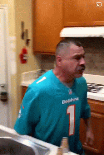 Man in Dolphins Jersey Standing in Kitchen