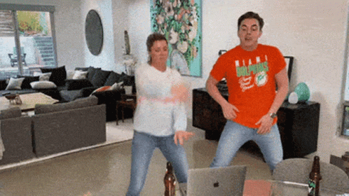 Man In Dolphins Shirt Dancing With Woman GIF