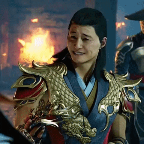 Man in Dragon Armor Smiling by Fire