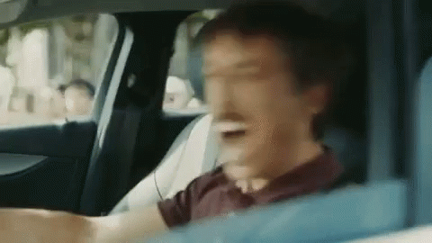 Man in Driver's Seat Making Funny Face