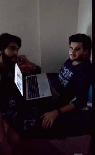 Man in Duke Shirt Sitting in Front of Laptop